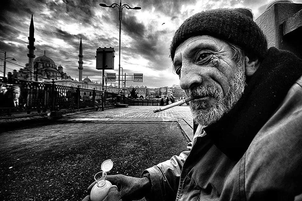 lack and white street image with dynamic shadows and light of older bearded man.