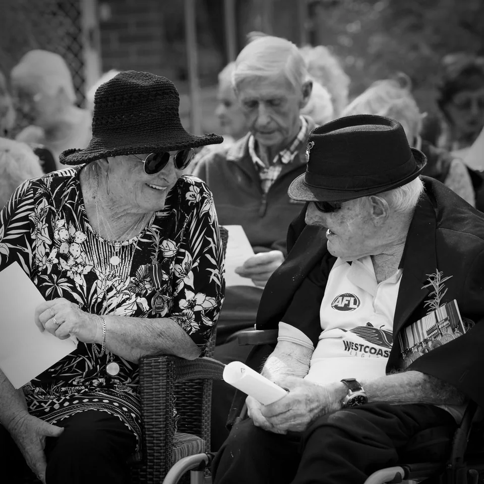 An elderly couple at an Anzac Day gathering — photograph by Peter Pickering