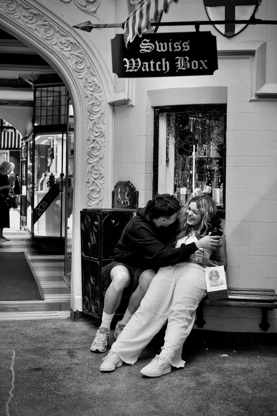 Young lovers on a bench laughing