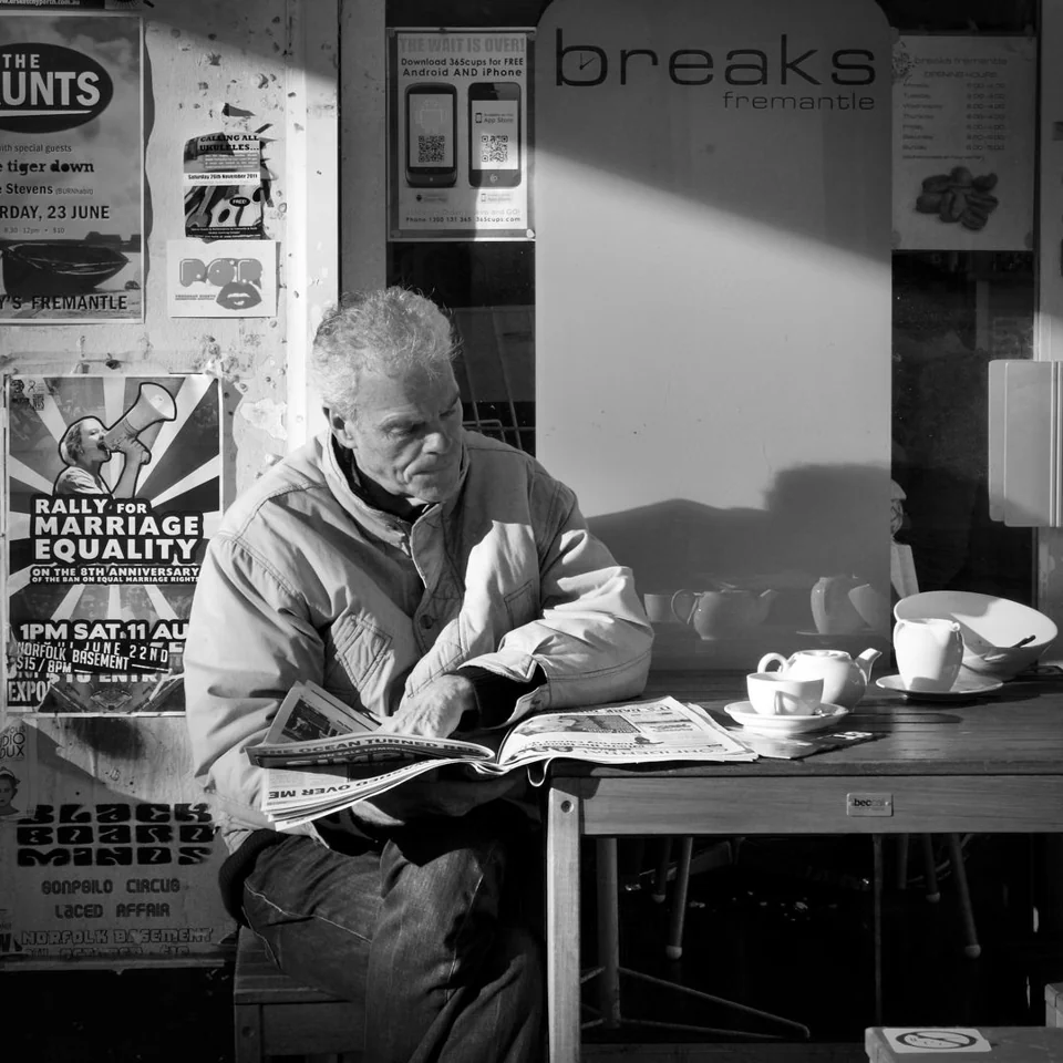 Man reading paper whilst drinking coffee - Peter Pickering Street Photography