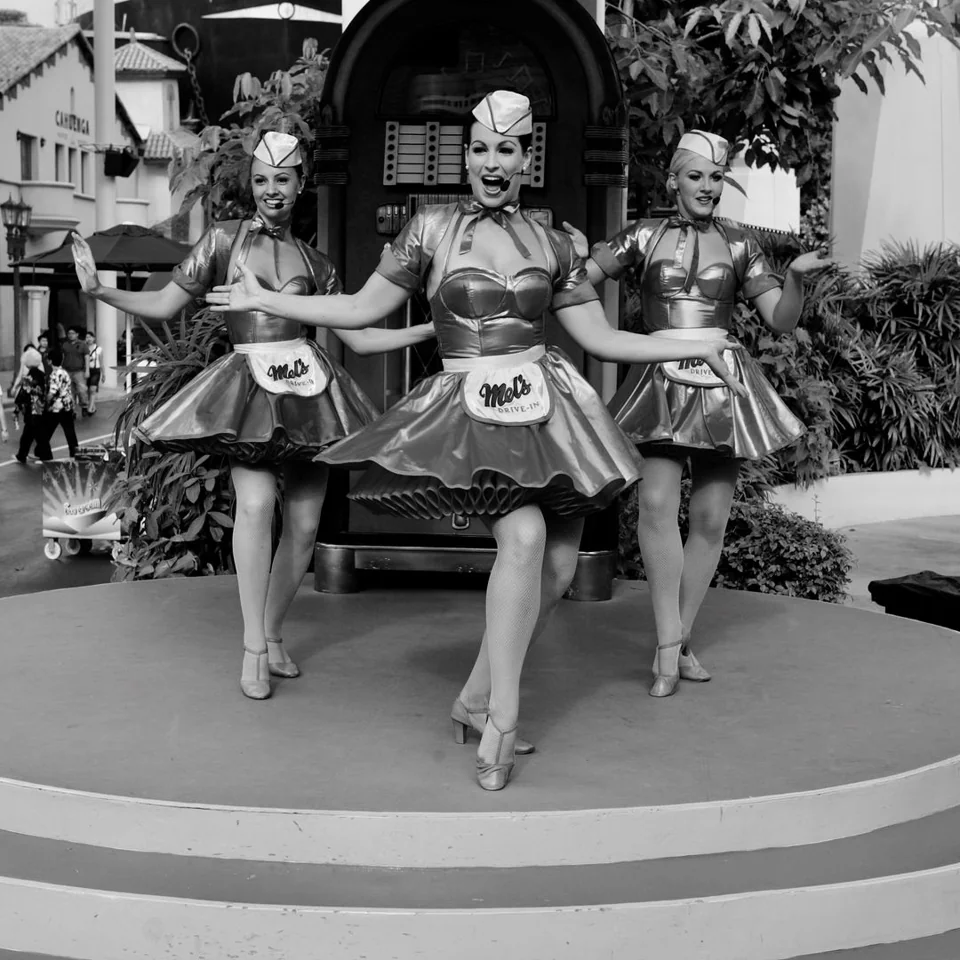 Three dancers performing outdoors — photograph by Peter Pickering