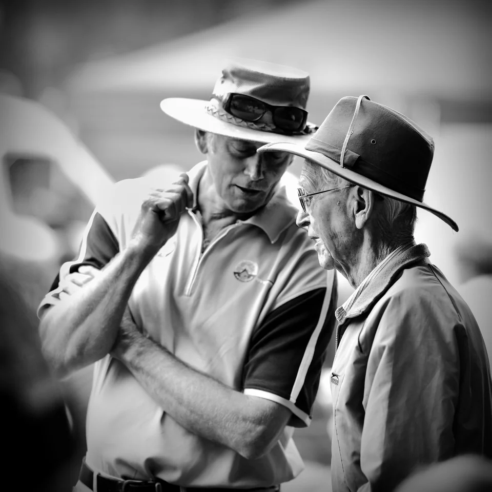 Two men in brimmed hats share a conversation — photograph by Peter Pickering