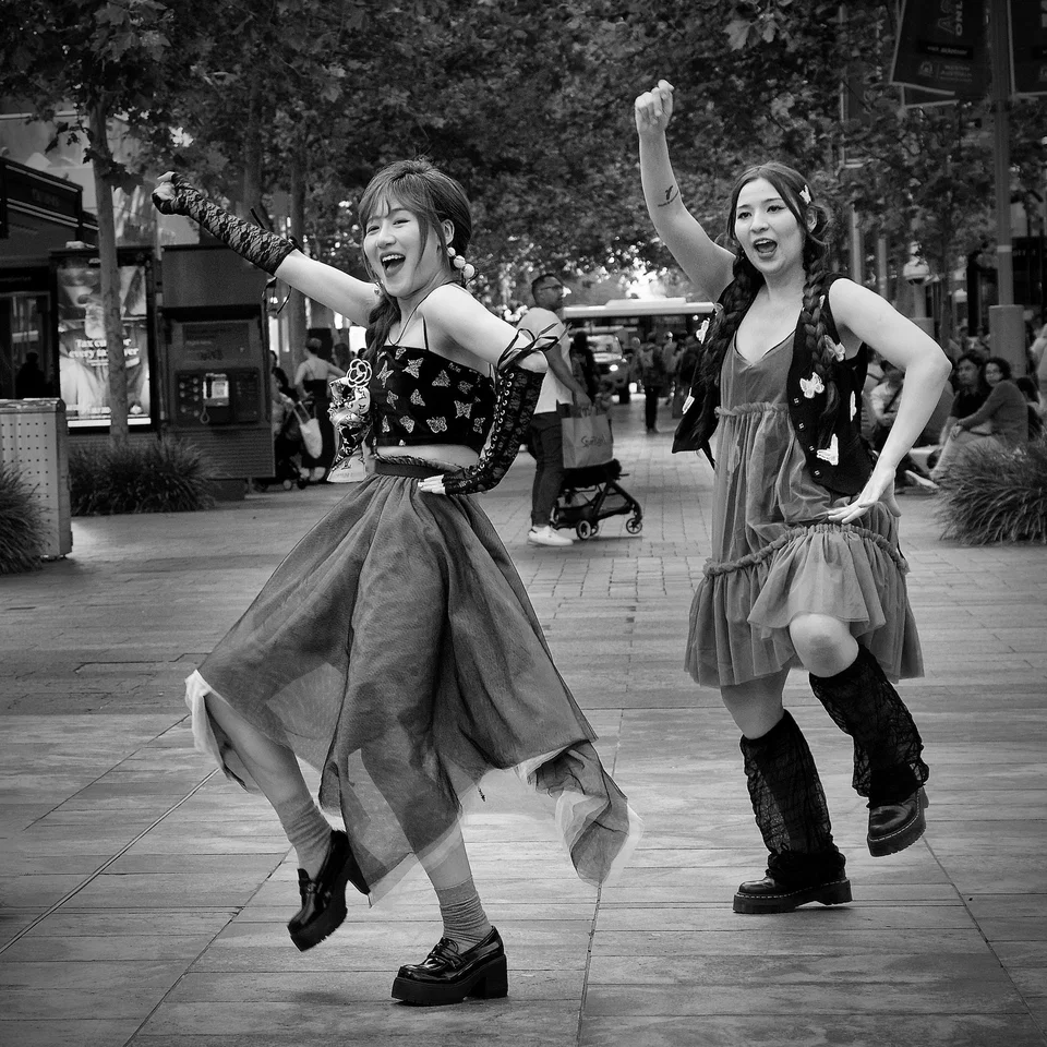 Two dancers perform in an open shopping street — photograph by Peter Pickering