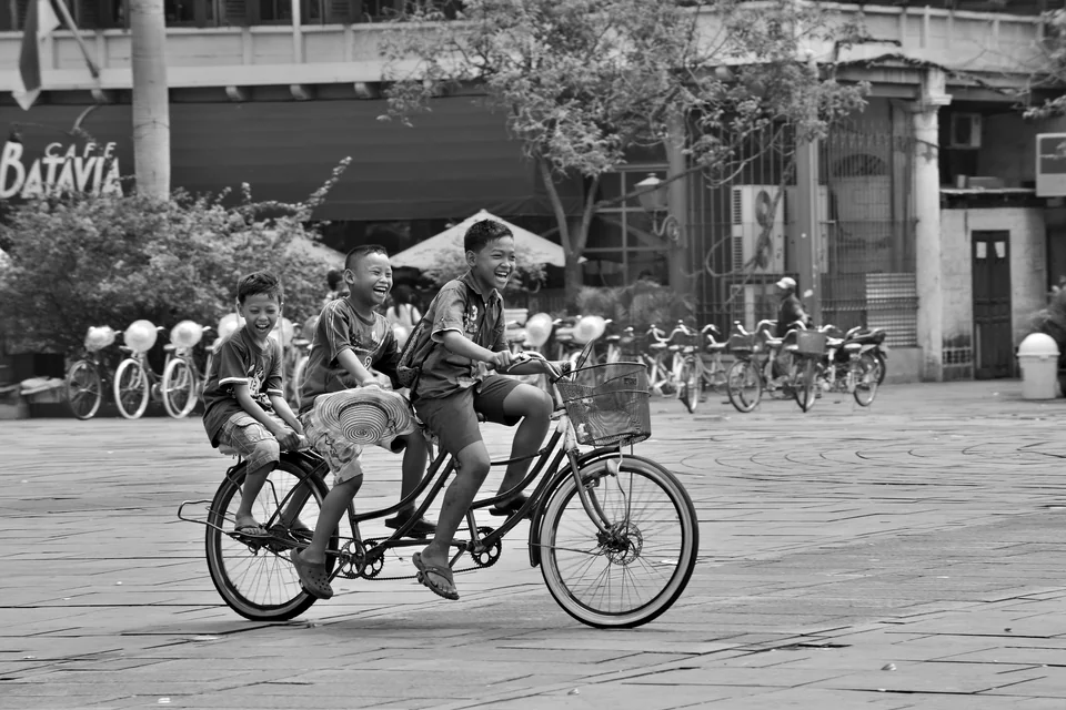 Several riders share a bicycle — photograph by Peter Pickering
