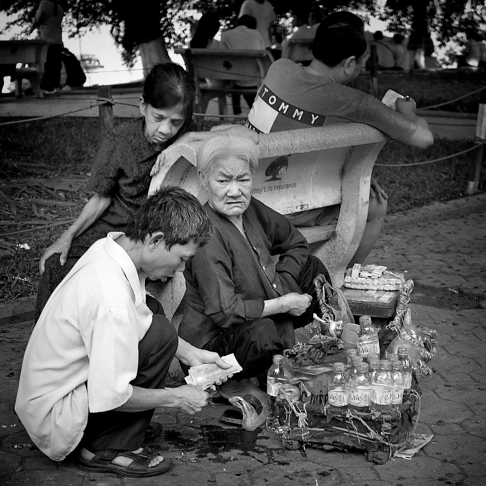 People gather around a street-side board game — photograph by Peter Pickering