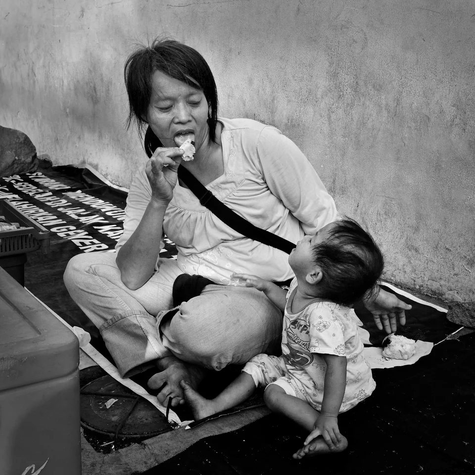 A woman and child share a quiet moment — photograph by Peter Pickering