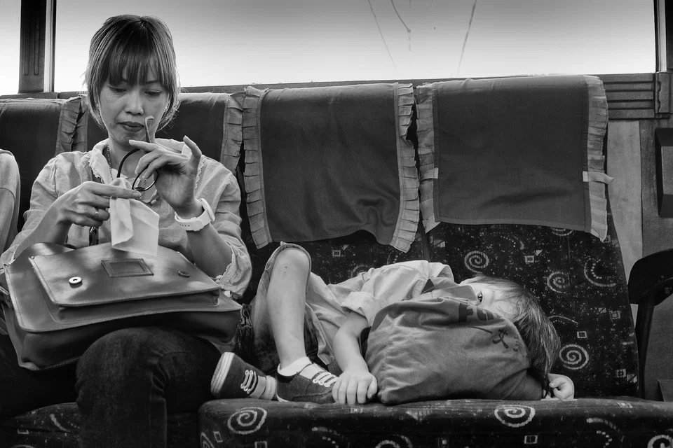 Two children occupy a bench seat — photograph by Peter Pickering