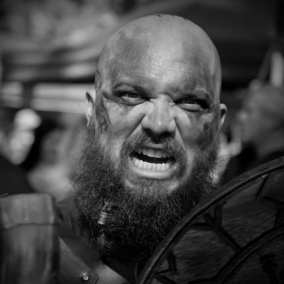 A bearded performer looks directly at the camera — photograph by Peter Pickering